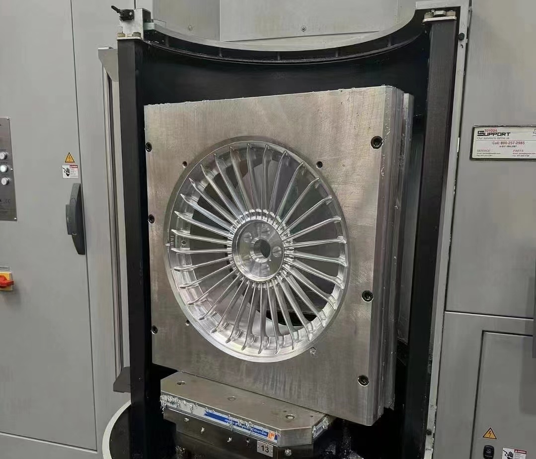 Machining equipment arranged for repeatable alloy wheel processing