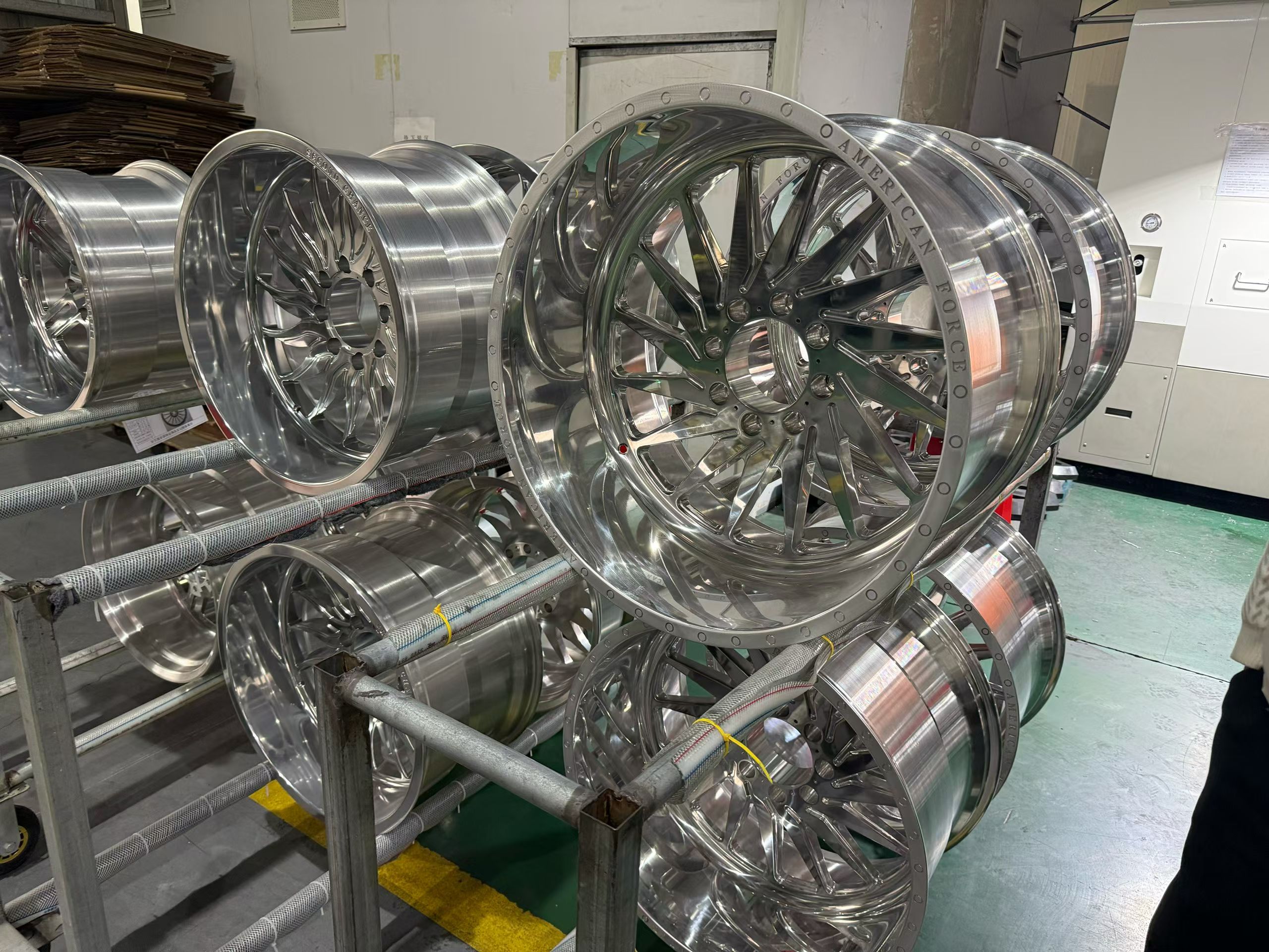 Finished alloy wheels displayed on production rack after quality inspection