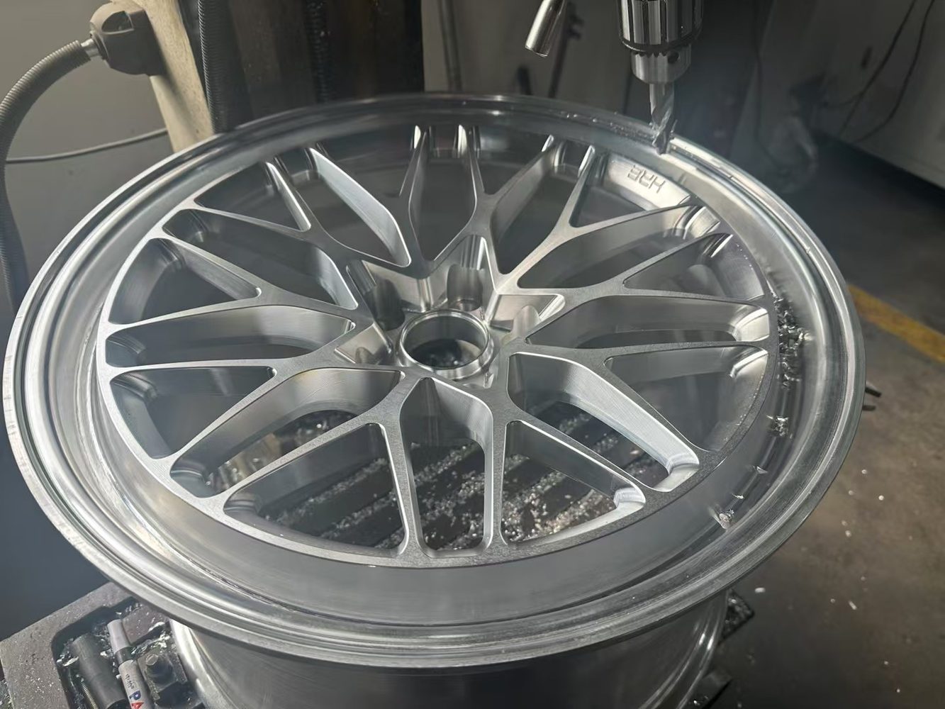 CNC machining detail during forged alloy wheel manufacturing