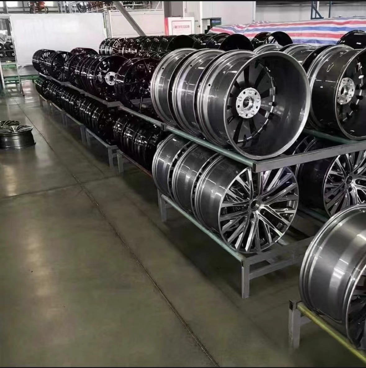 Alloy wheel staging racks in a factory warehouse