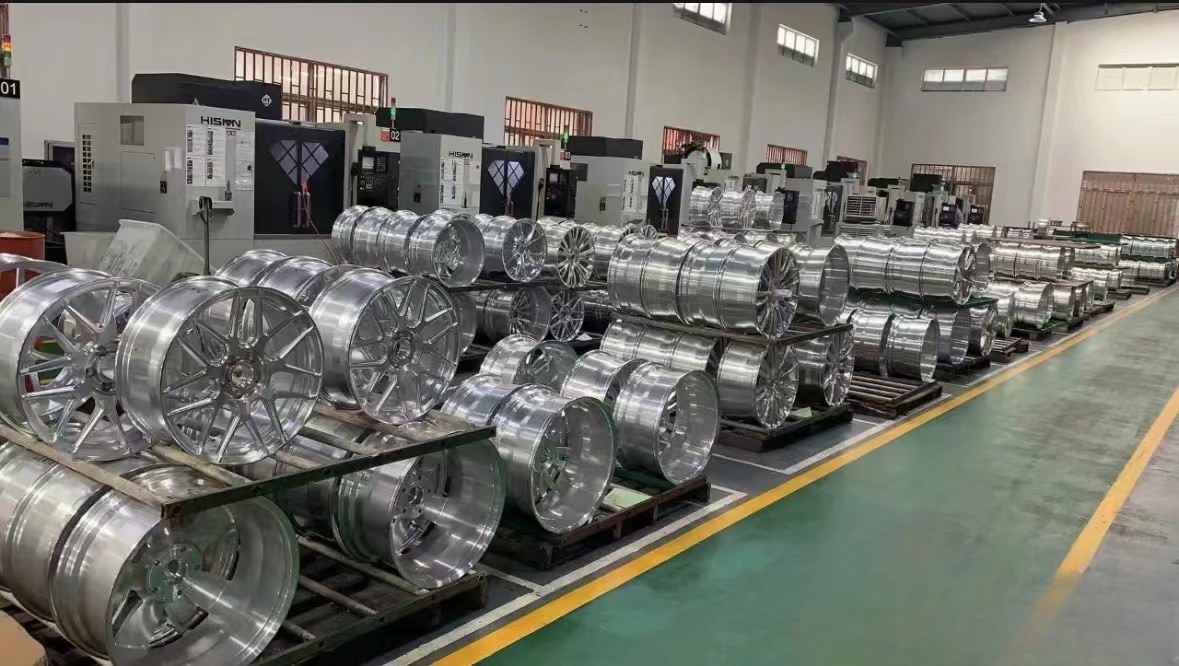 Wheel production workshop with multiple machine stations and organized billet handling