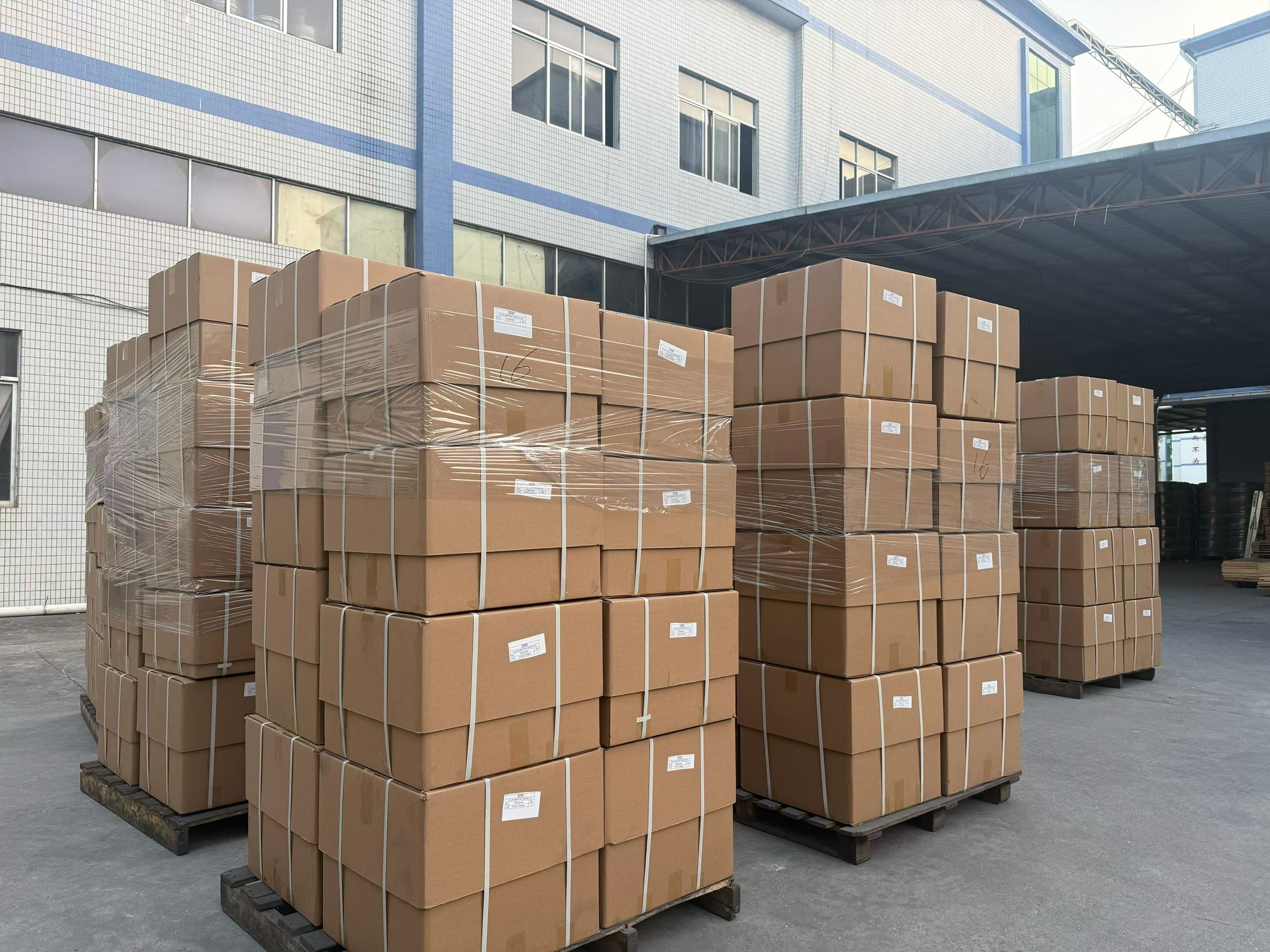 Export cartons of alloy wheels loaded on pallets at the factory yard