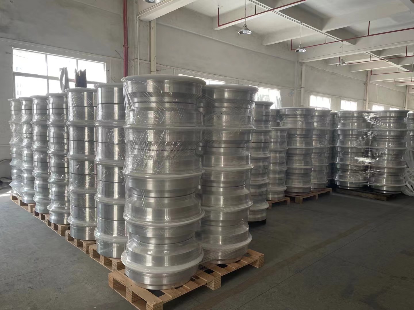 Alloy wheel inventory staged inside the production workshop