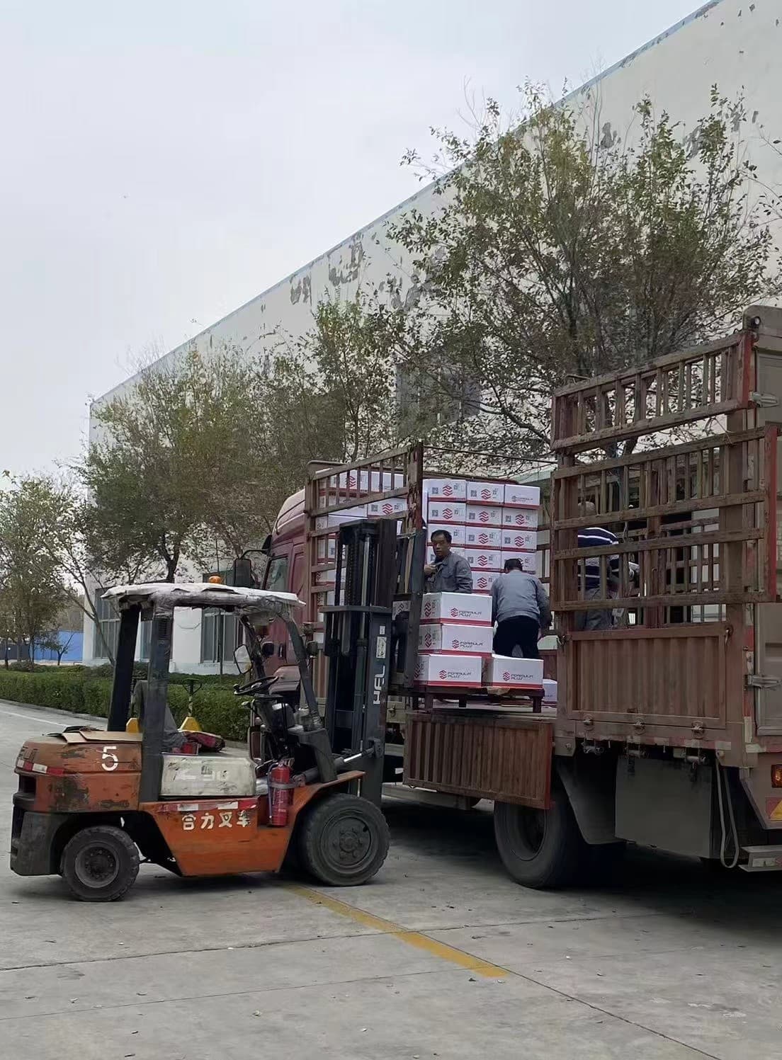 Forklift unloading alloy wheel production materials outside the factory