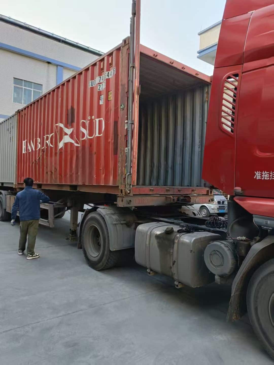 Truck trailer positioned for alloy wheel export loading outside the factory