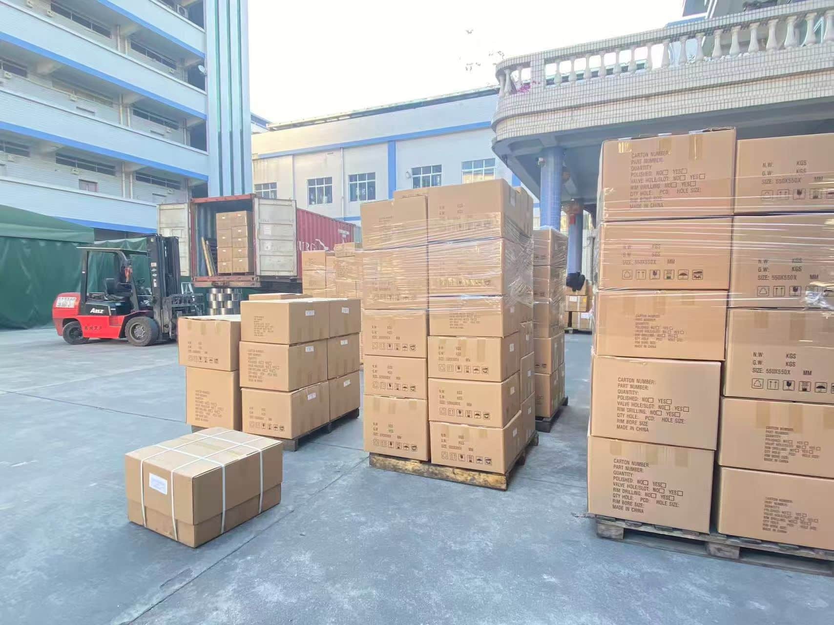 Alloy wheel cartons staged outdoors before final container loading