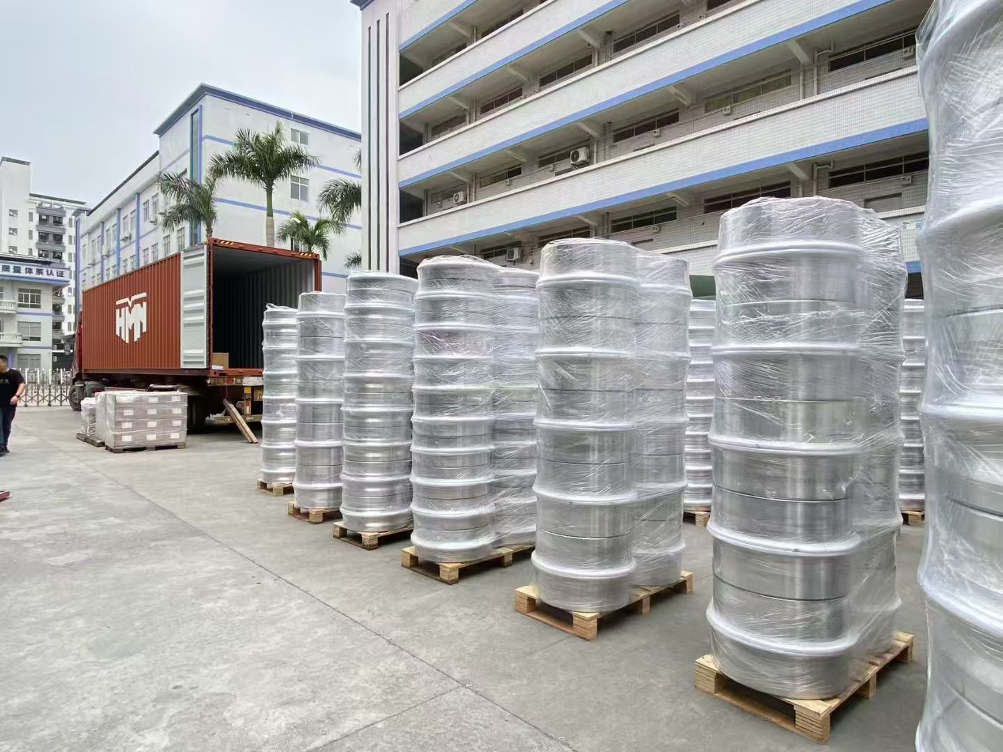 Palletized alloy wheel sets staged with cartons and protective wrapping