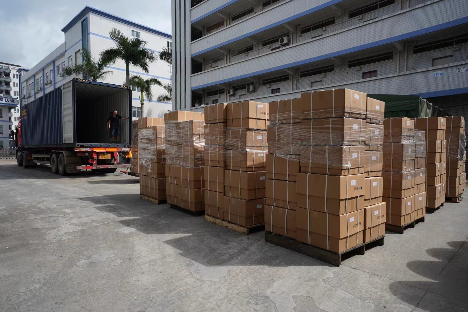 Export yard photo of grouped alloy wheel cartons ready for dispatch